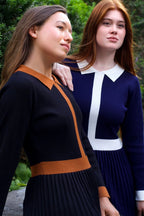 Two women wearing Clarissa knit dress in black and navy with contrast trim
