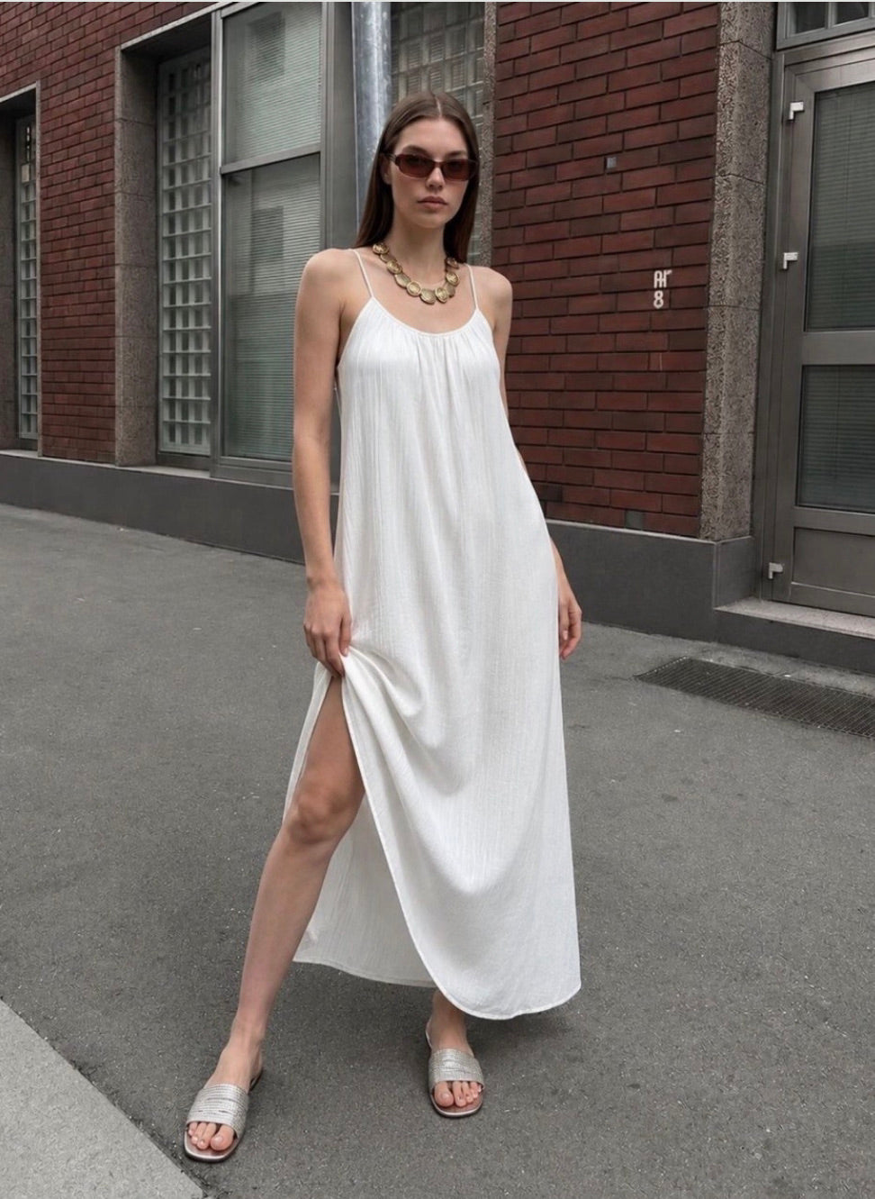 White spaghetti strap maxi slip dress with side slit worn outdoors - ANAZ Maxi Muslin Slip Camisole Summer Dress White
