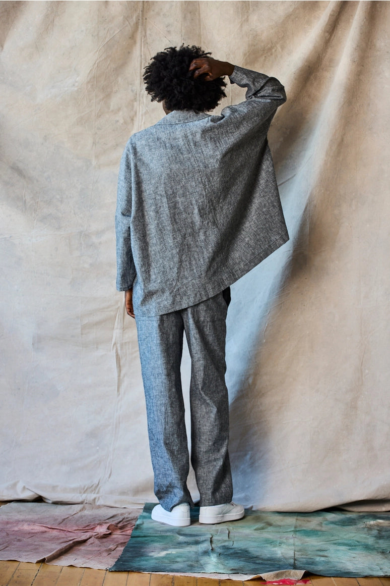 Man wearing a gray suit standing against a beige curtain Devlyn van Loon