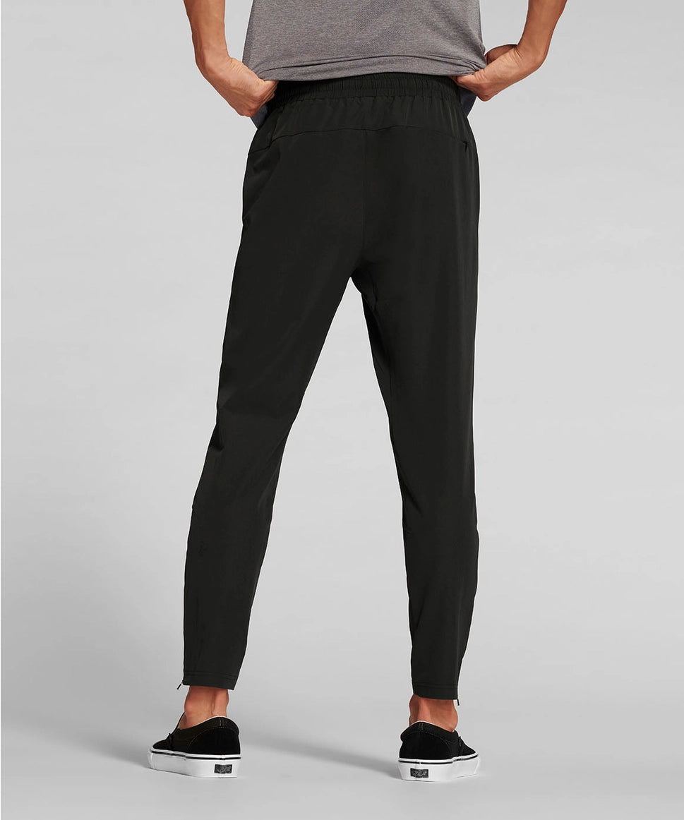 Man wearing black jogger pants on a gray background RYU