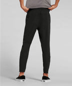 Man wearing black jogger pants on a gray background RYU