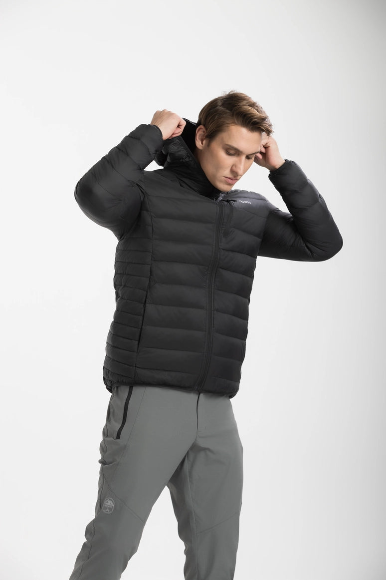 Man wearing a black puffer jacket and gray pants on a white background Aparso