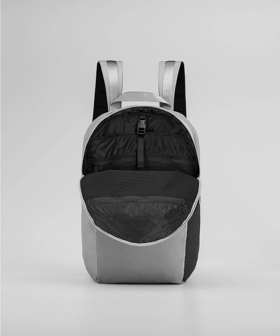 Gray backpack with open front compartment on a light gray background RYU