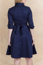 Navy blue dress with a belt on a beige background ANNICK