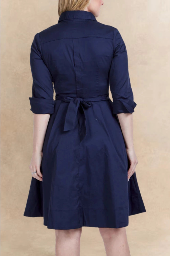 Navy blue dress with a belt on a beige background ANNICK