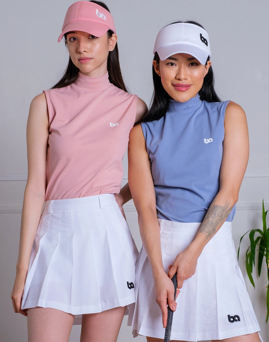 Two women in tennis outfits with visors and skirts, holding a tennis racket.