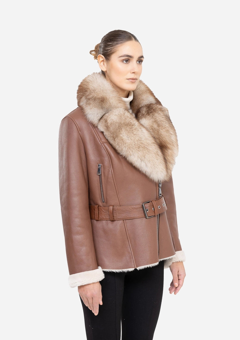 Woman wearing a brown leather jacket with fur collar on a white background Cuir Dimitri 