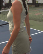 Person on a tennis court holding a sports ball