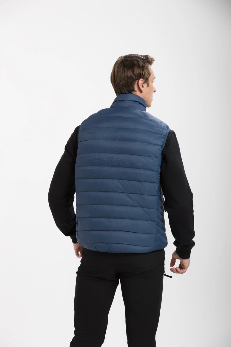 Man wearing a blue puffer vest on a white background Aparso