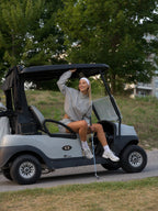 Woman in cloud grey BOV Active Mia half zip jacket sitting in golf cart