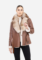 Woman wearing a brown leather jacket with fur collar on a white background Cuir Dimitri 