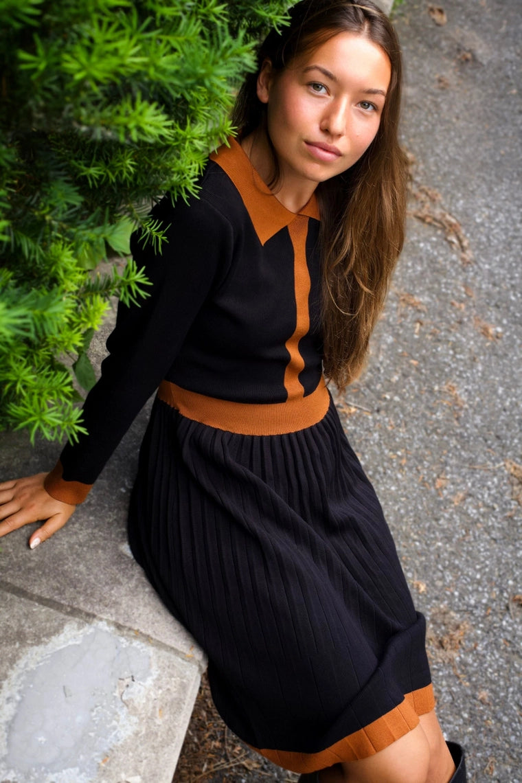 Side view of woman wearing Clarissa knit dress in black with contrast collar

