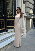 Woman in a white dress standing in front of a building entrance. Standpoint Top