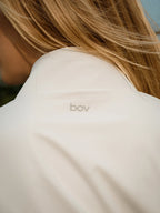 Close-up of a beige garment with 'bov' branding.