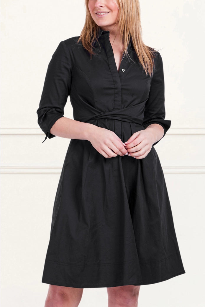 Woman wearing a black dress against a white background ANNICK