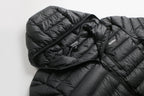 Black puffer jacket with a brand logo on a light gray background Aparso