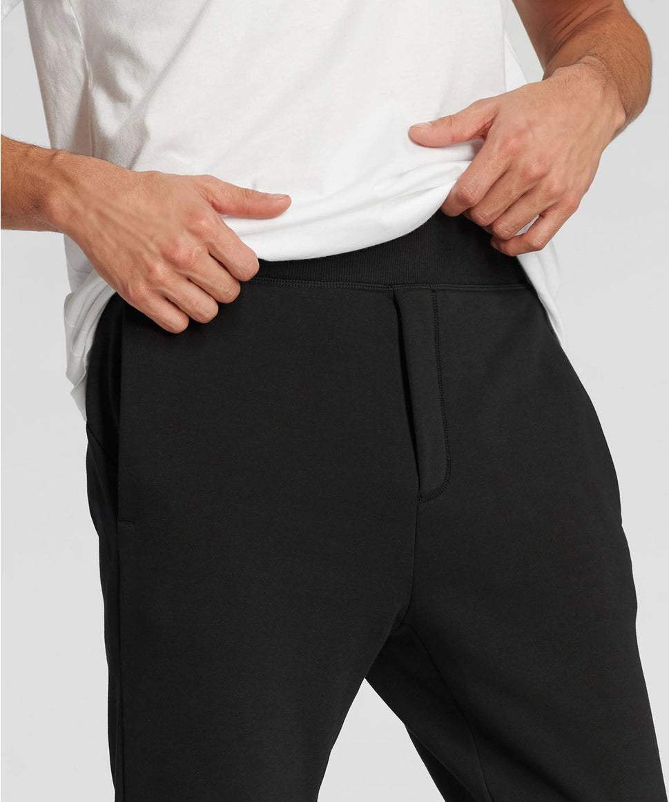 Man wearing black pants with a plain background RYU
