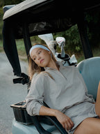 Woman in cloud grey BOV Active Mia half zip jacket sitting in golf cart