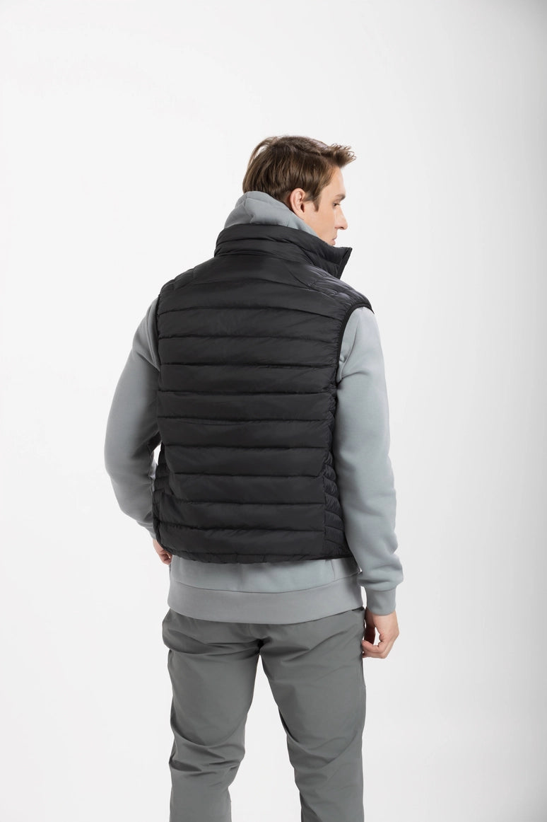 Women wearing a black puffer vest over a gray outfit on a white background Aparso