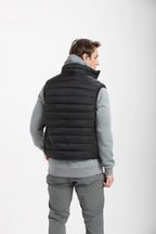Women wearing a black puffer vest over a gray outfit on a white background Aparso