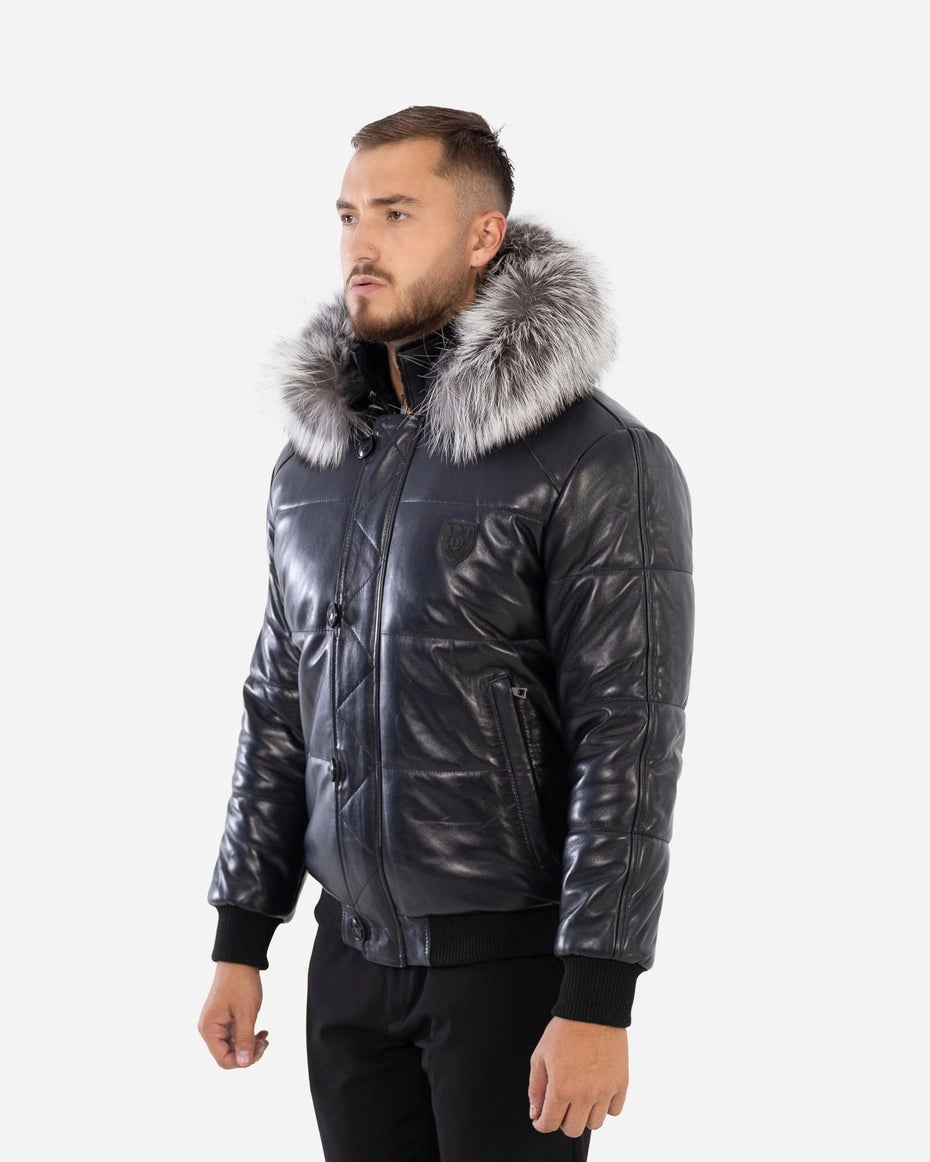 Man wearing a black leather jacket with fur hood on a white background 