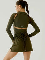 Woman wearing an olive green athletic outfit with a brand logo on a light gray background BOV Active