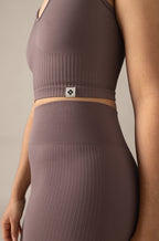 Brown ribbed sports bra and leggings set on a neutral background