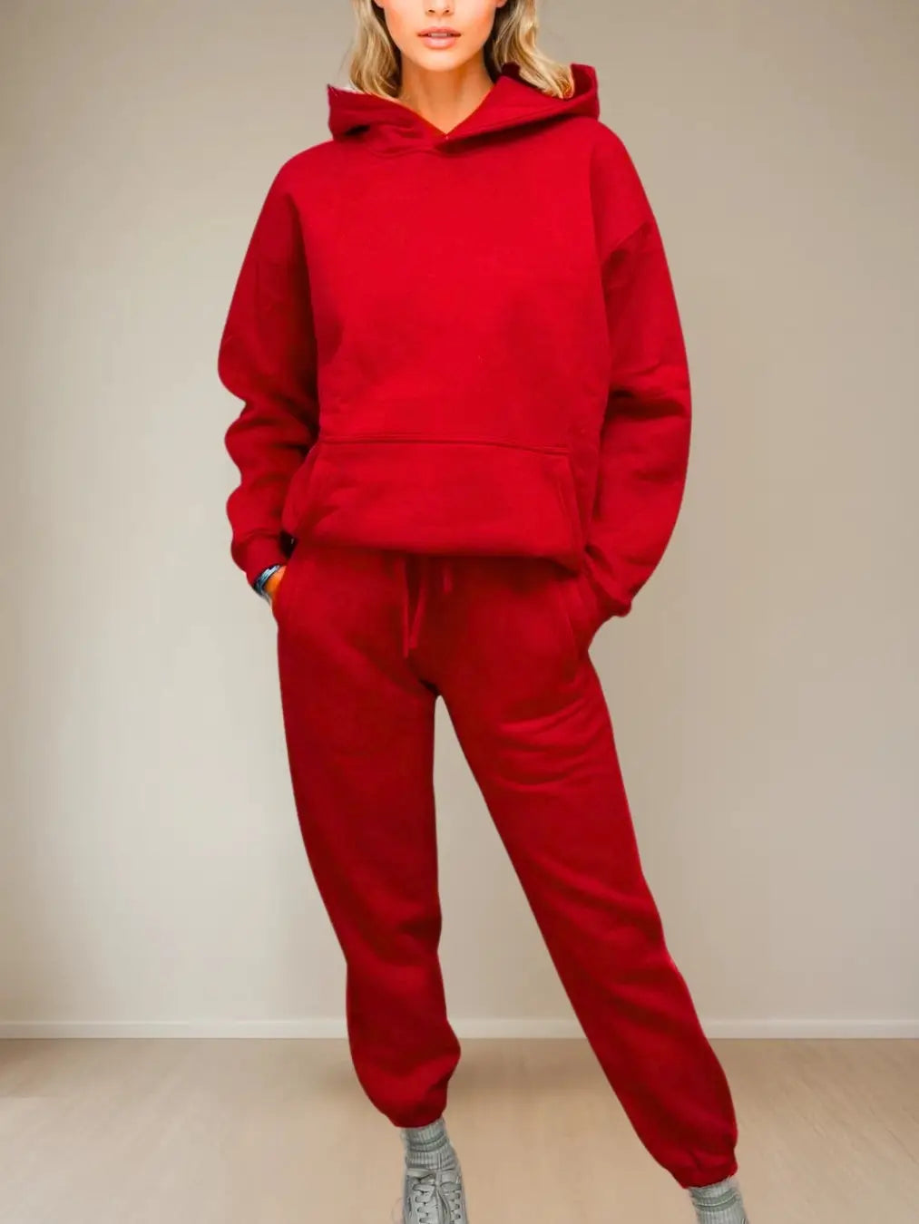Women wearing a red tracksuit against a plain background PRIV