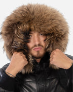 Man wearing a black leather jacket with a fur-lined hood on a white background Cuir Dimitri